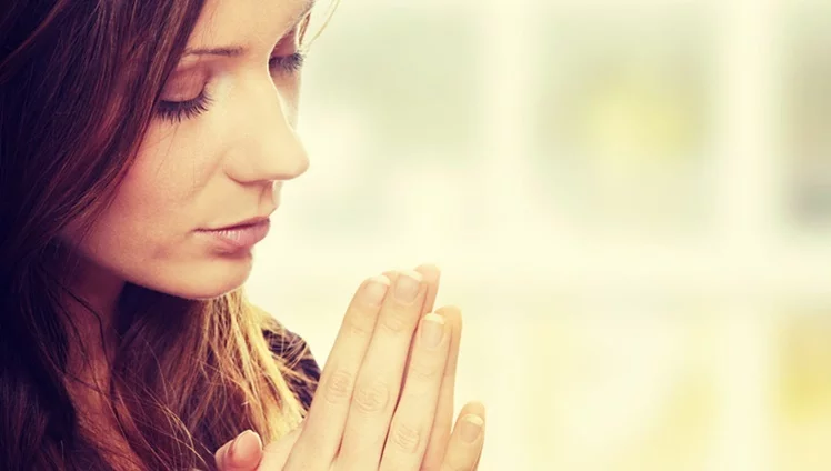 Closeup Portrait Of A Young Caucasian Woman Praying